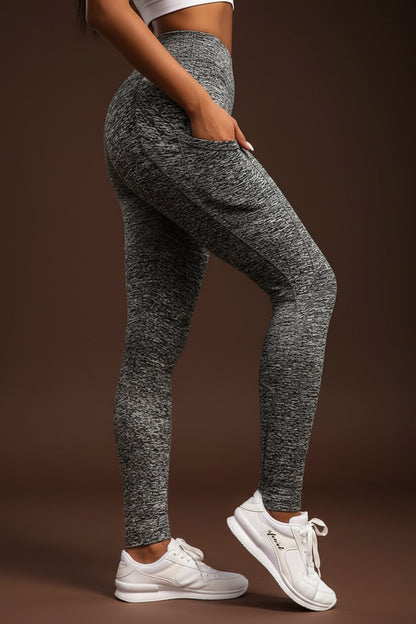 Woman wearing grey patterned leggings with a side pocket