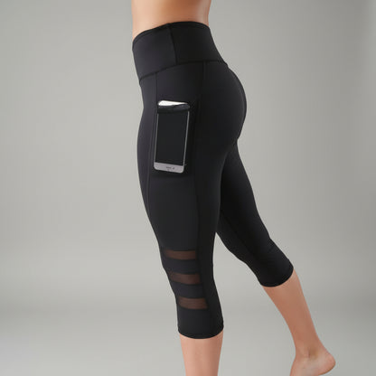 Black capri leggings with a phone in the side pocket