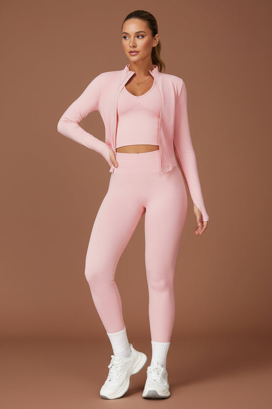 Woman wearing pink 3-piece yoga set, jacket and leggings