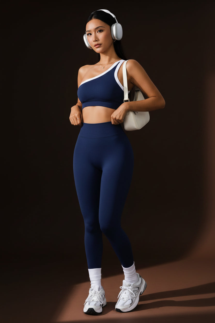 ImageWoman wearing navy high-waist yoga leggings and sports bra set, front view"