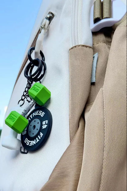 Fitness-themed keychains attached to a bag