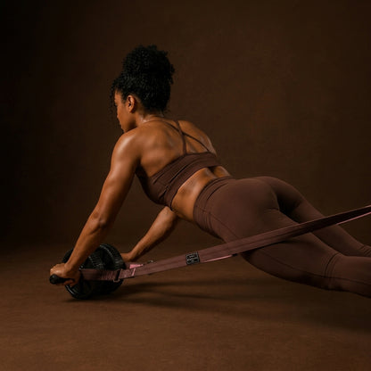 Woman using a floor roller with resistance straps
