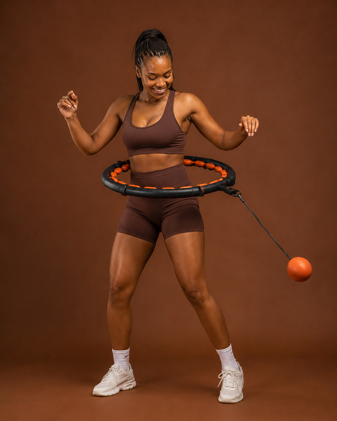 Woman using adjustable weighted hula hoop for waist toning