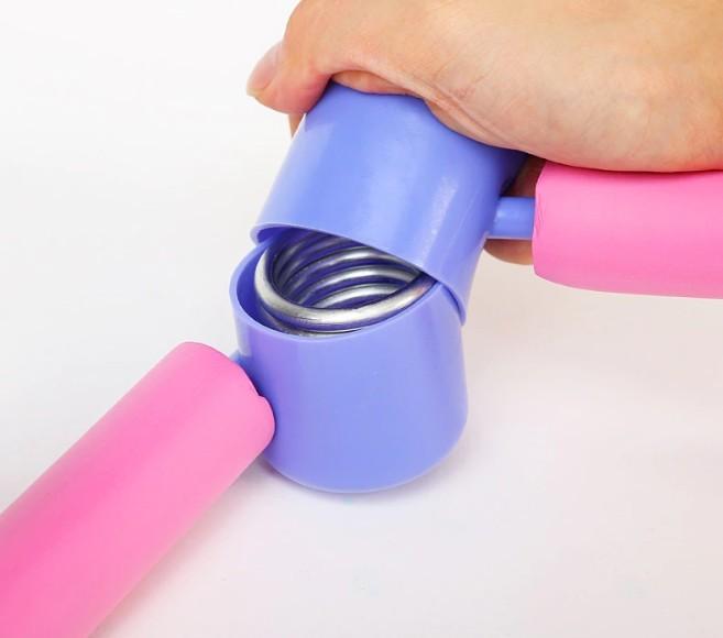 close-up  of the durable steel spring hinge mechanism inside a blue plastic casing on a pink thigh exerciser
